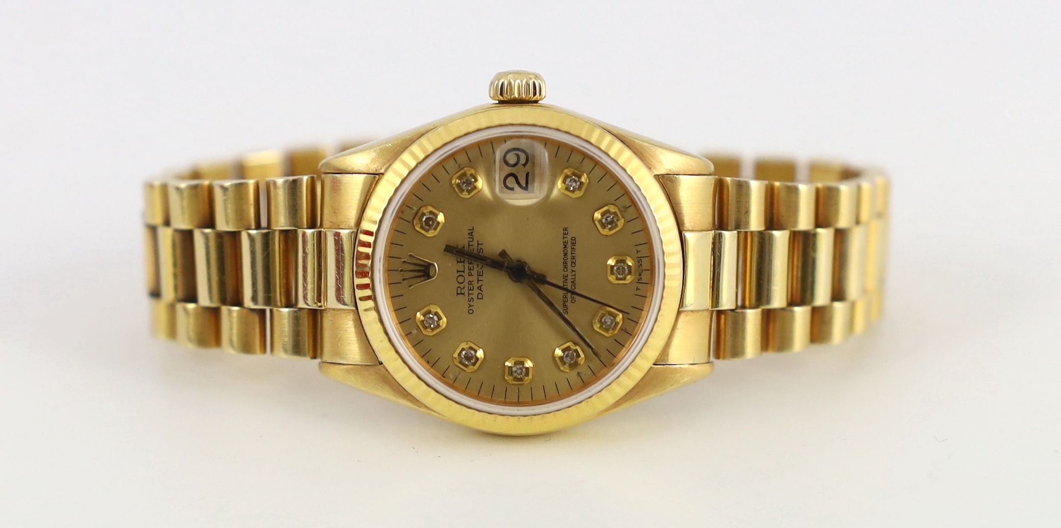 A lady's early 1970's 18ct gold Rolex Oyster Perpetual Datejust wrist watch, with diamond dot numerals, on an 18ct gold Rolex bracelet, with deployment clasp